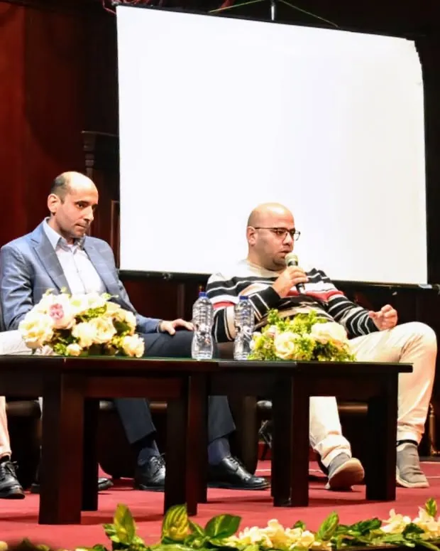 Two speakers in conversation on stage